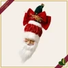 Babbo Natale da appendere con grande fiocco rosso e cappello verde, altezza 25 cm
