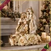 Natività in resina e tessuto avorio e oro su composizione floreale, altezza 60 cm